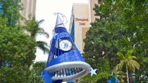 The blue Mikey magician hat with a Disneyland logo on it and the Disneyland Hotel in the background in Los Angeles, California, USA